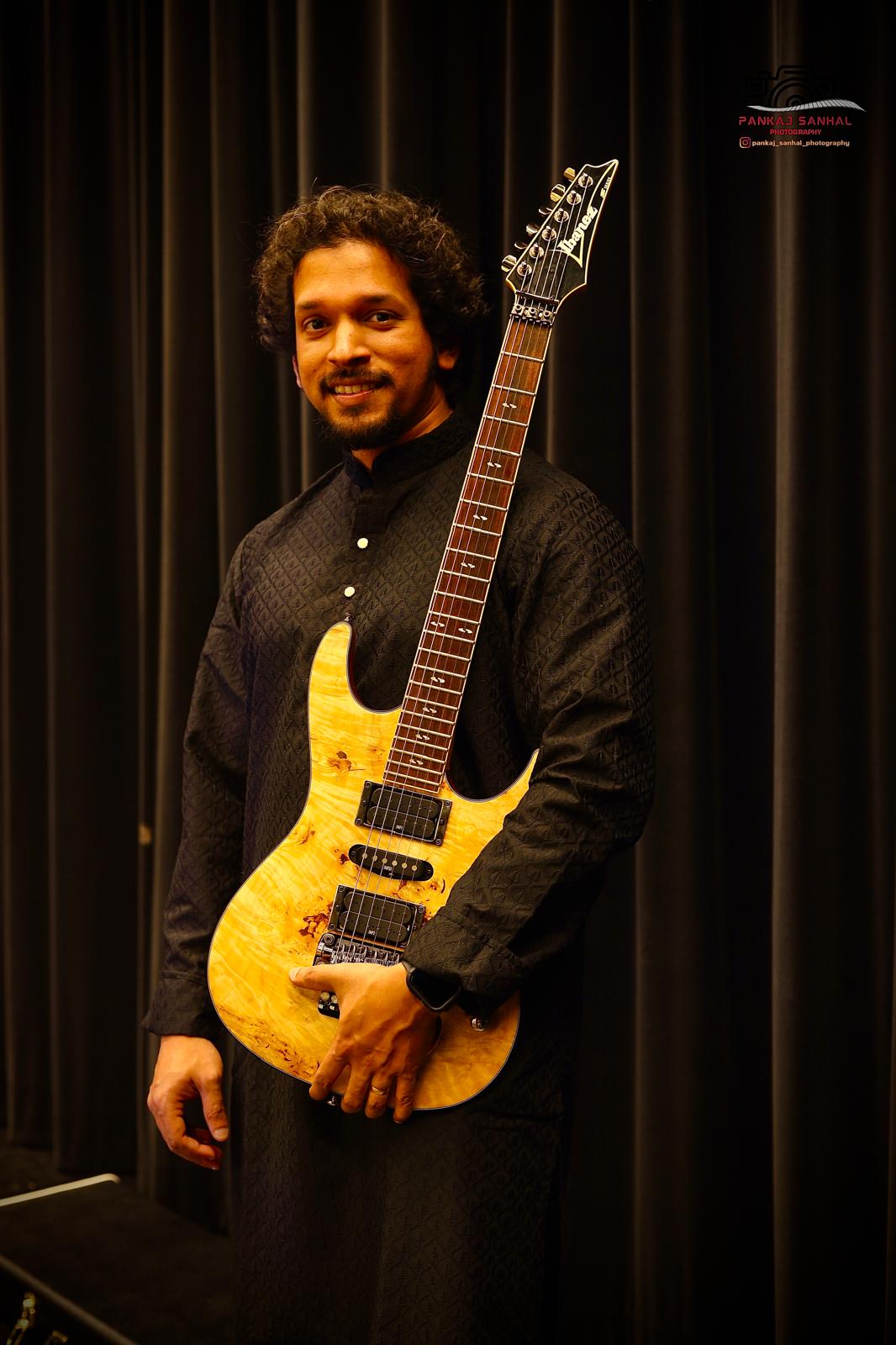 Glen Fernandez portrait with guitar