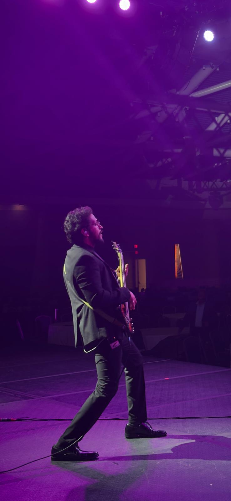Glen Fernandez performing under stage lights