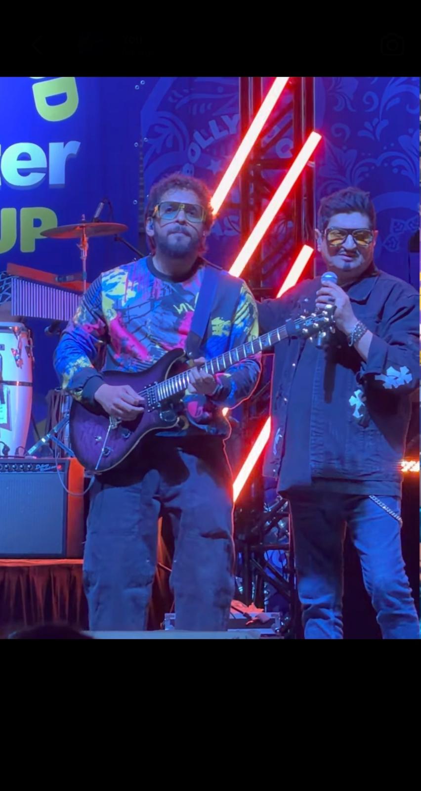 Glen Fernandez performing with guitar